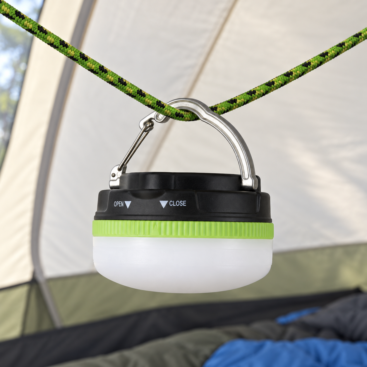 LP1503 mini lantern hanging unlit inside a tent from its deployed aluminum clip on a braided cord