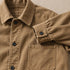 Close view of the chore coat collar, buttons, cuffs and twill texture