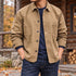 Khaki chore coat worn over a navy shirt outdoors