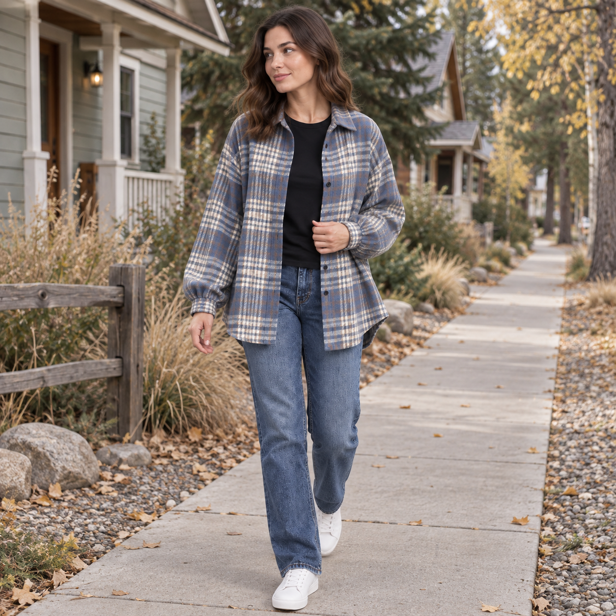Woman walking through a pine-lined bungalow neighborhood wearing the Bluehaven blue-gray plaid shacket