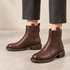 Briarwalk dark-brown ankle boots worn with cropped trousers, showing the low heels and rounded toes