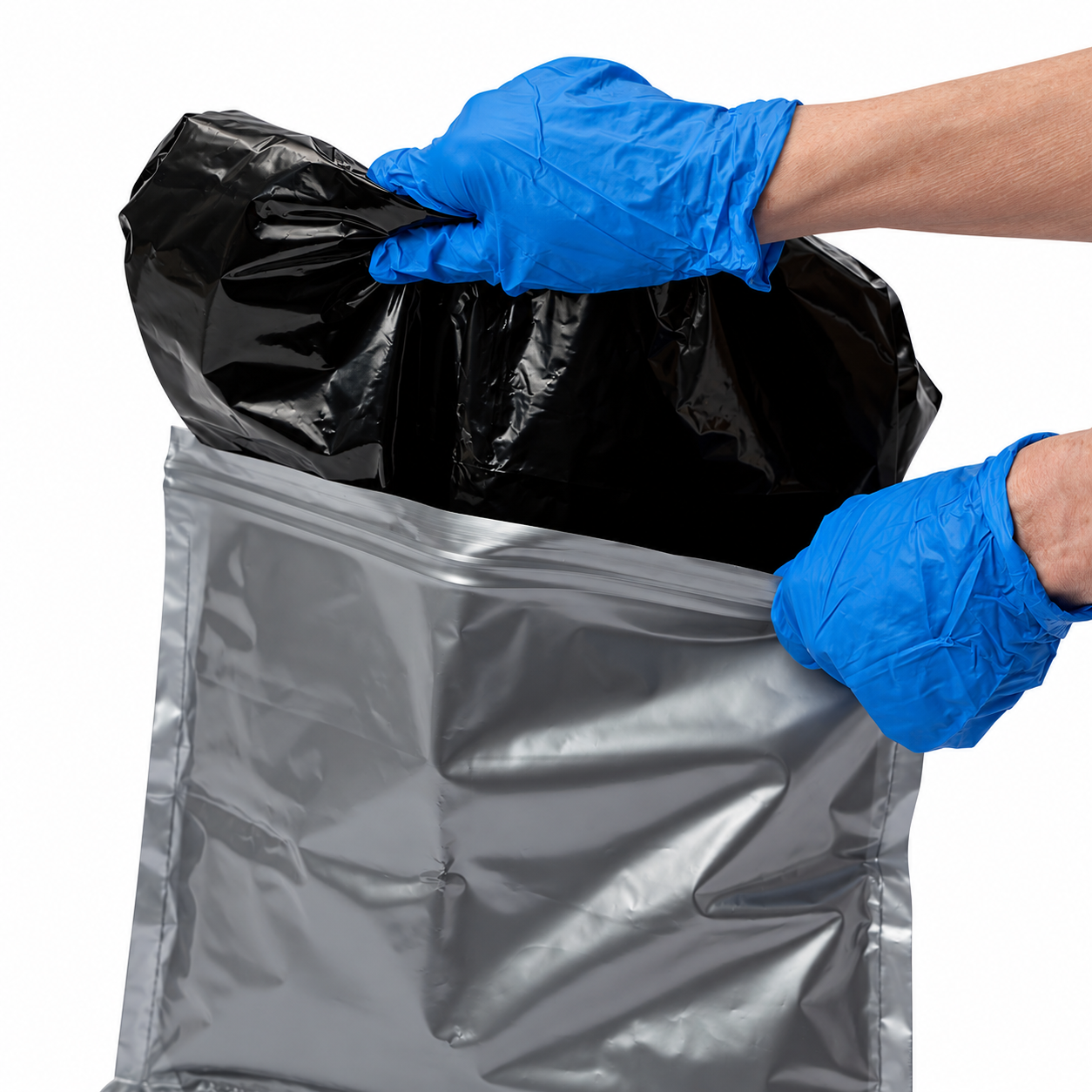 Close-up of a black Double Doodie Plus inner bag inside its gray outer bag, with the outer closure edge held open by blue-gloved hands.