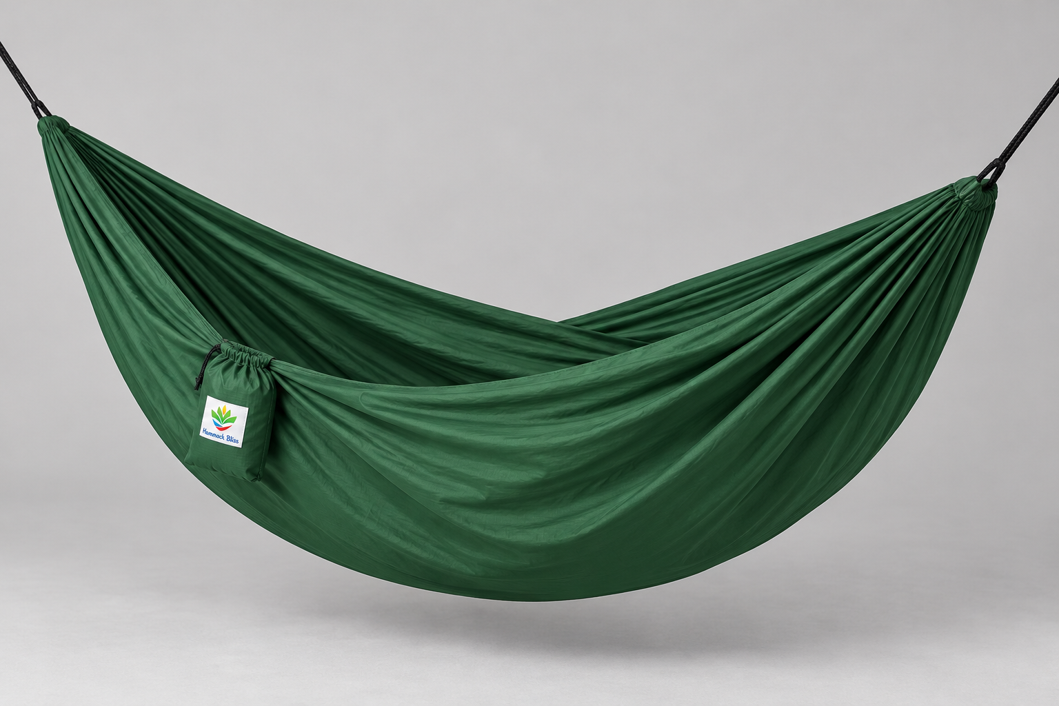 Forest Green Hammock Bliss Single hammock deployed in a supported studio view with its attached stuff sack