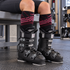 Women's Summit ski sock cuffs visible above black alpine ski boot liners in a resort boot room.