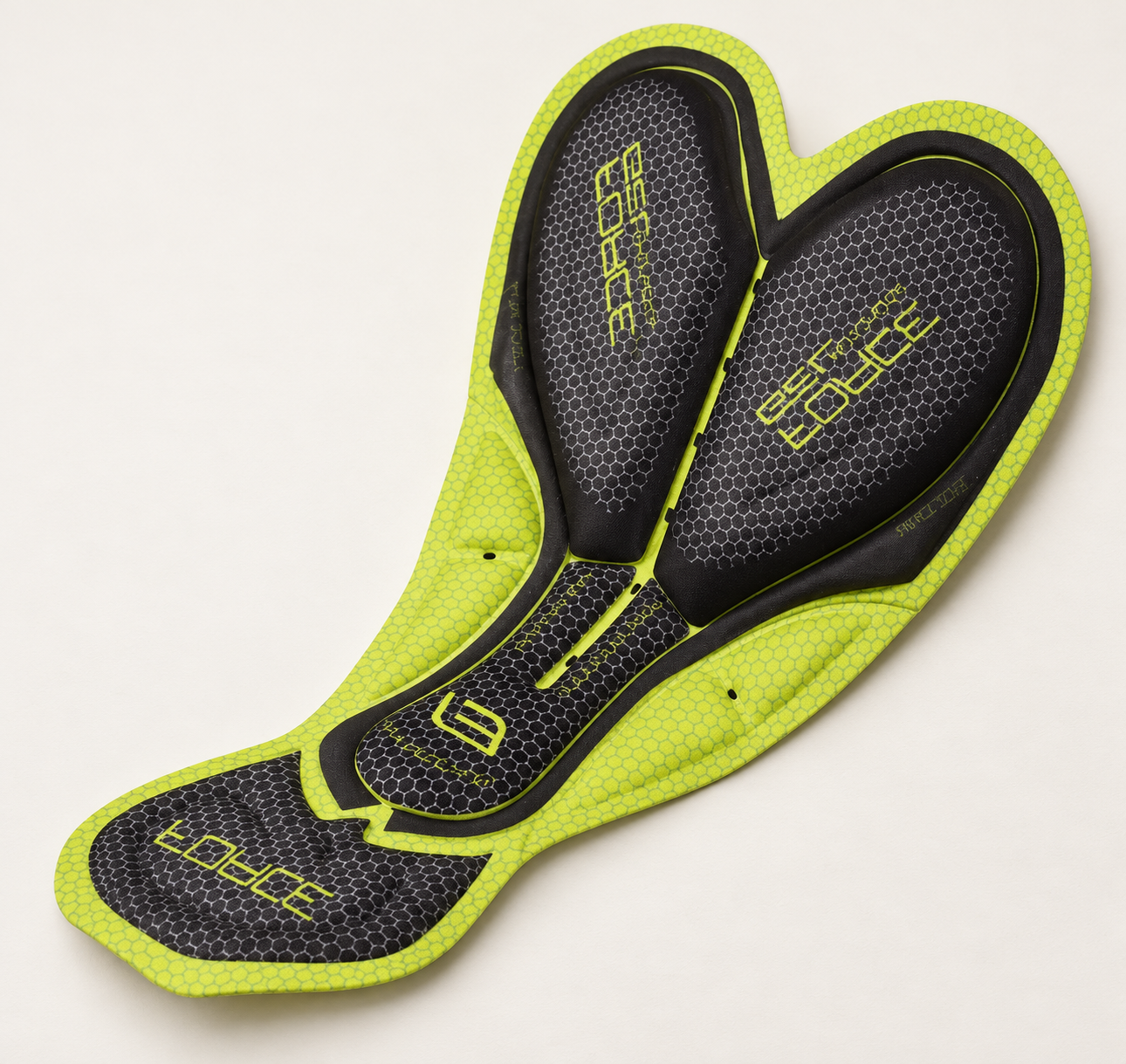 Illustrative close-up of the lime-green and black interior cycling pad used in DAREVIE DVP008 bib shorts, showing its contoured panels and honeycomb-patterned surface