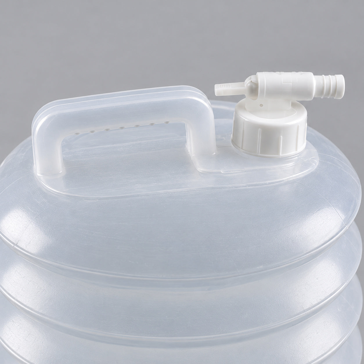 Close-up of the AceCamp jerrycan tap, screw collar and carry handle