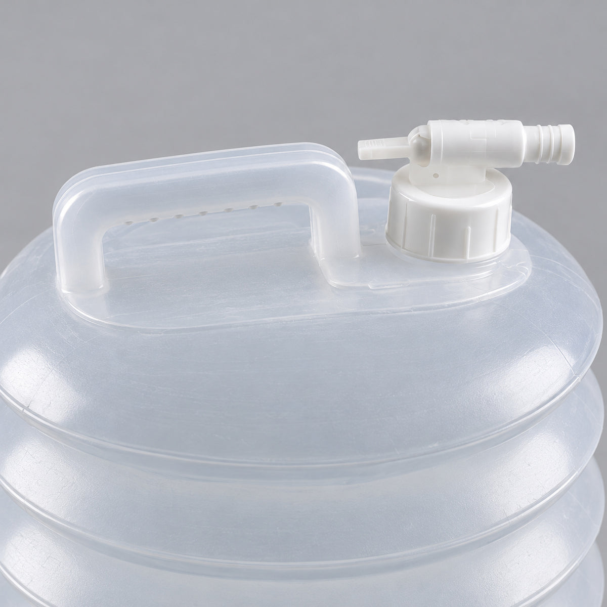 Close-up of the AceCamp jerrycan tap, screw collar and carry handle