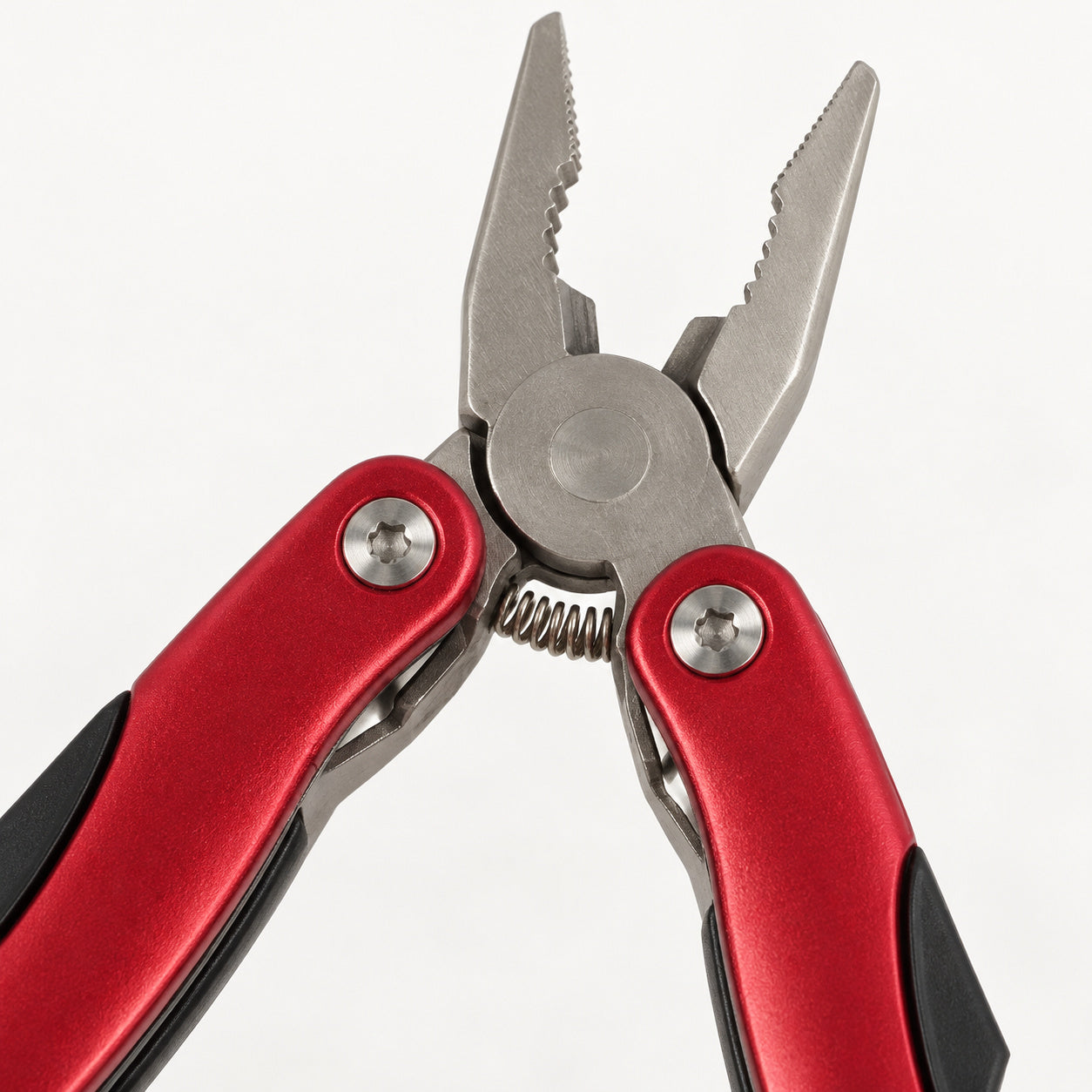 Close-up of the AceCamp multi tool plier jaws, spring and red handle pivots