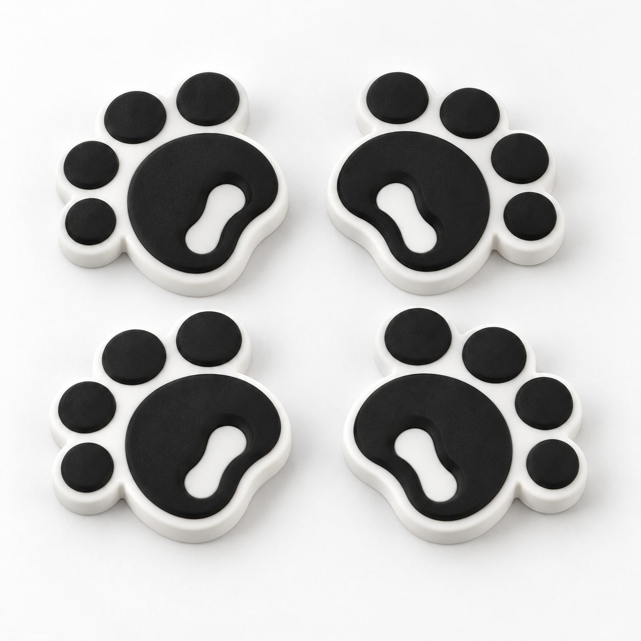 Four black pawprint snowboard stomp pads with white bases