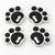 Four black pawprint snowboard stomp pads with white bases
