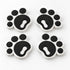 Four black pawprint snowboard stomp pads with white bases