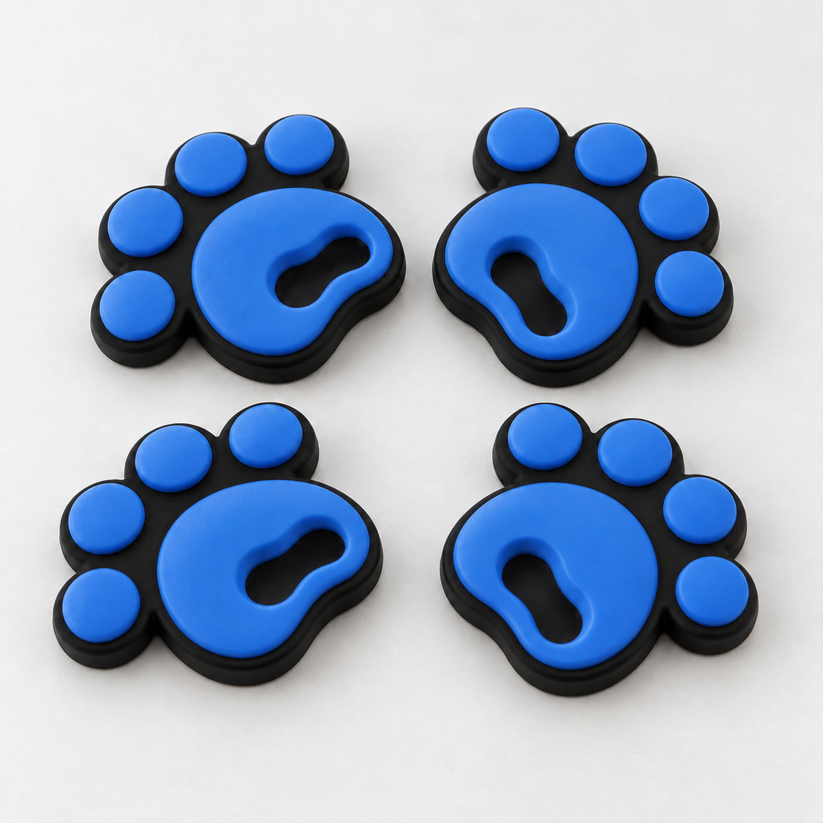 Four blue pawprint snowboard stomp pads with black bases
