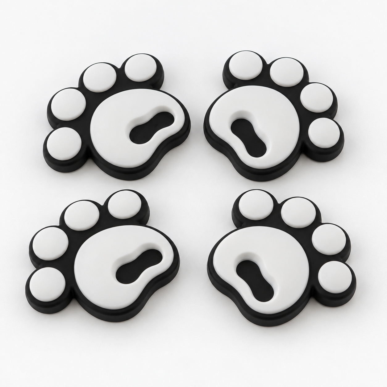 Four white pawprint snowboard stomp pads with black bases