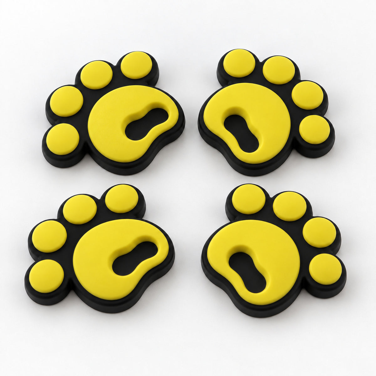 Four yellow pawprint snowboard stomp pads with black bases