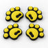 Four yellow pawprint snowboard stomp pads with black bases