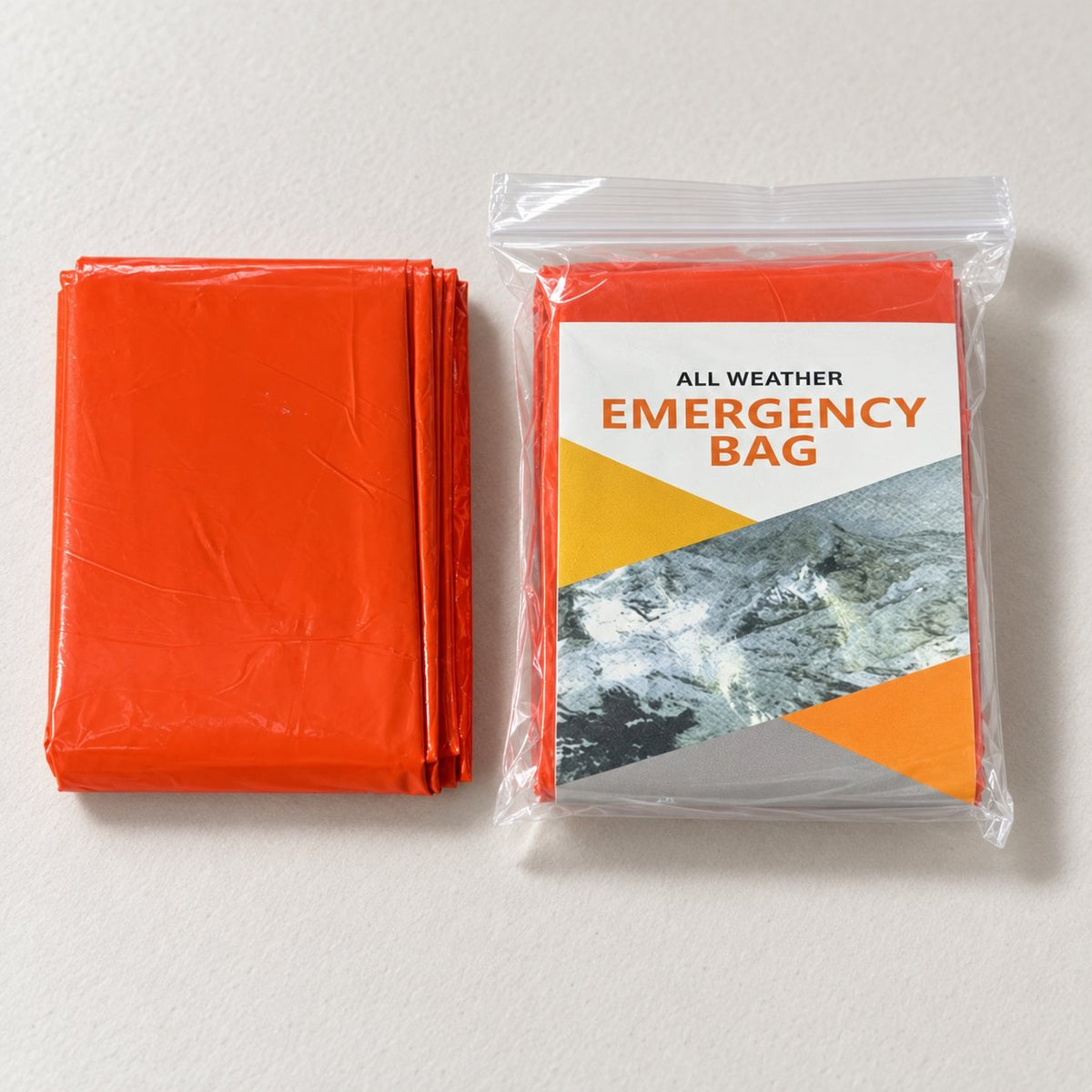 Folded orange bivy cover beside a retail-packed orange example with a printed insert, without a drawstring pouch