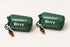 Two green packed bivy covers in drawstring pouches with two orange-and-black whistles