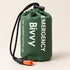 One green packed bivy cover in a drawstring pouch with an orange-and-black whistle
