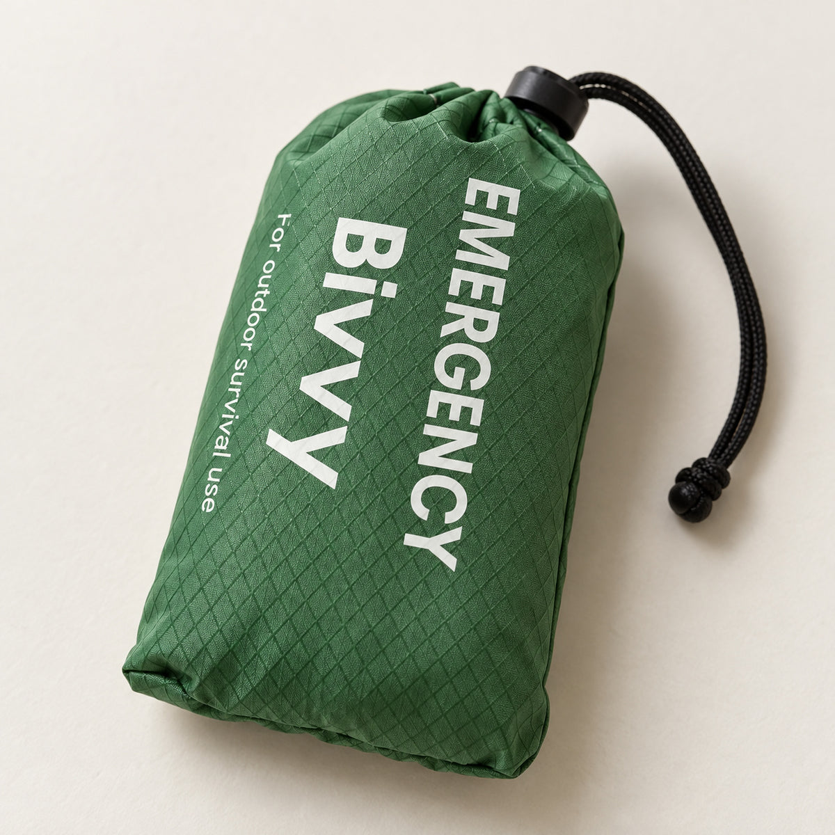 One green packed bivy cover in a drawstring pouch without a whistle