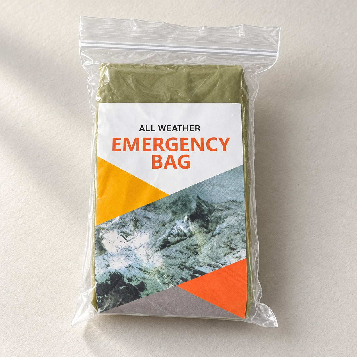 One folded olive-green bivy cover in a clear retail sleeve with a printed insert, without a drawstring pouch
