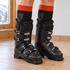 Bridgedale ski socks worn inside illustrative black ski boots, with orange cuffs visible above the collars.