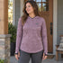 BlackStrap Women's Brackish Sun Hoody in Ferns Mauve, worn with the hood down.