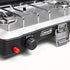 Close view of the Coleman Triton+ ignition button, burner control and carry-handle latch