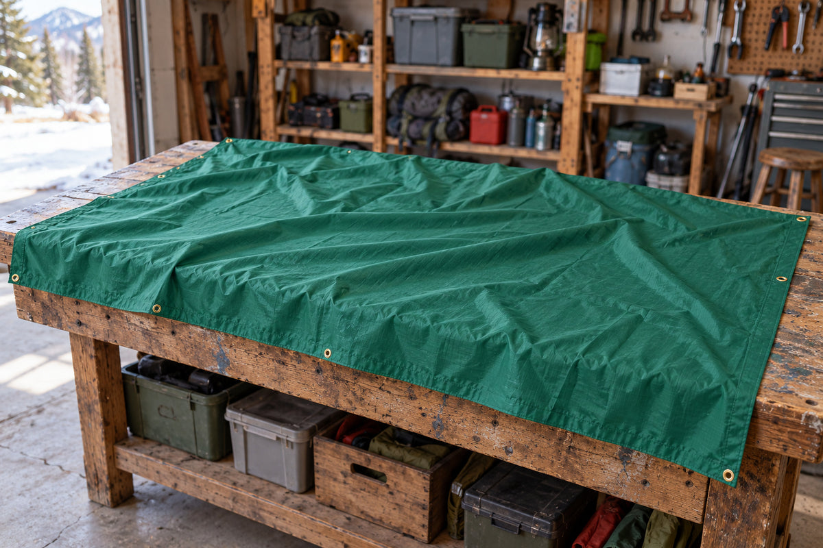 A green Equinox Egret tarp draped across a home gear-packing workbench.