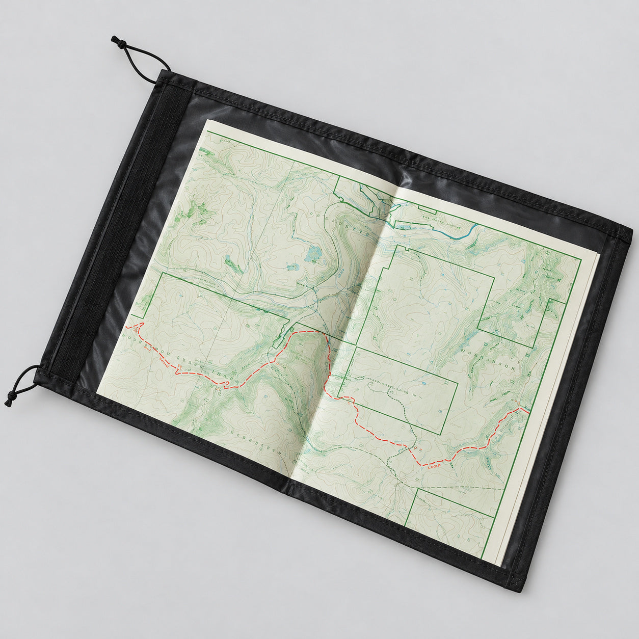 Equinox Hellbender Ultralite Map Case Large in black trim with a map visible.