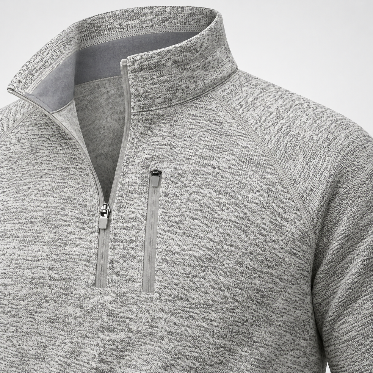 Close view of the light gray quarter-zip pullover stand collar, quarter zipper, vertical zip chest pocket.