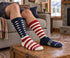 Fox River Old Glory Ski socks worn with feet resting on a home footstool.