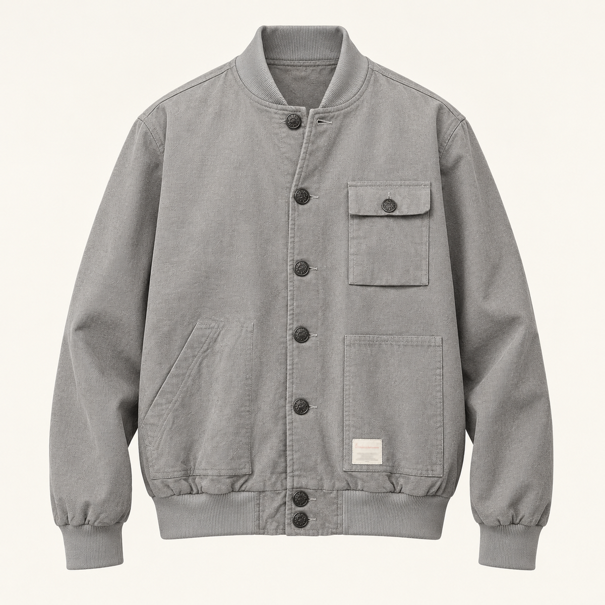 Front studio view of the gray seven-button blouson with asymmetric pockets.