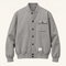 Front studio view of the gray seven-button blouson with asymmetric pockets.
