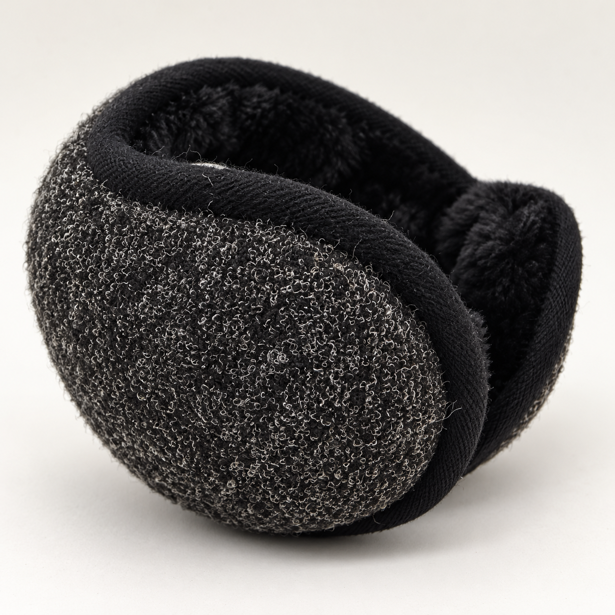 Close view of charcoal ear-warmer padding, plush lining, and folding form.