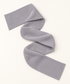 Full pale-gray rib-knit wrap scarf arranged end to end in studio.