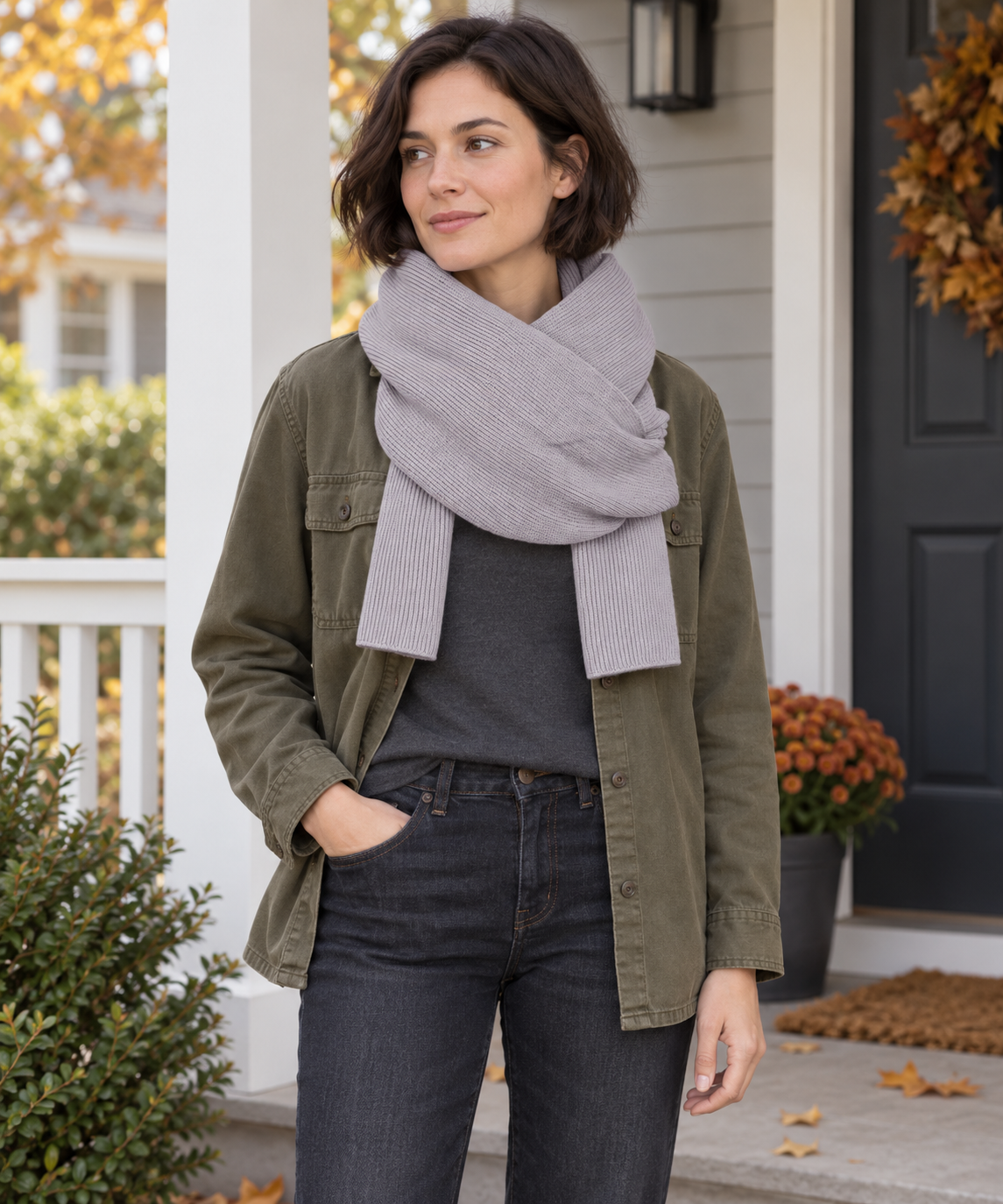 Adult wearing the pale-gray rib-knit wrap scarf in a crossed neck wrap.