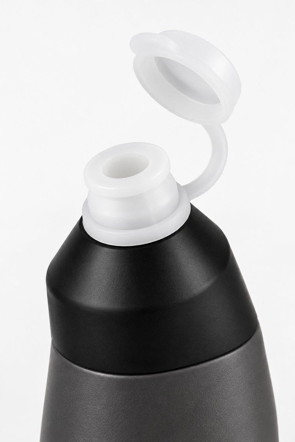 White pull-up drinking spout with its round dust cover open on the black bottle cap