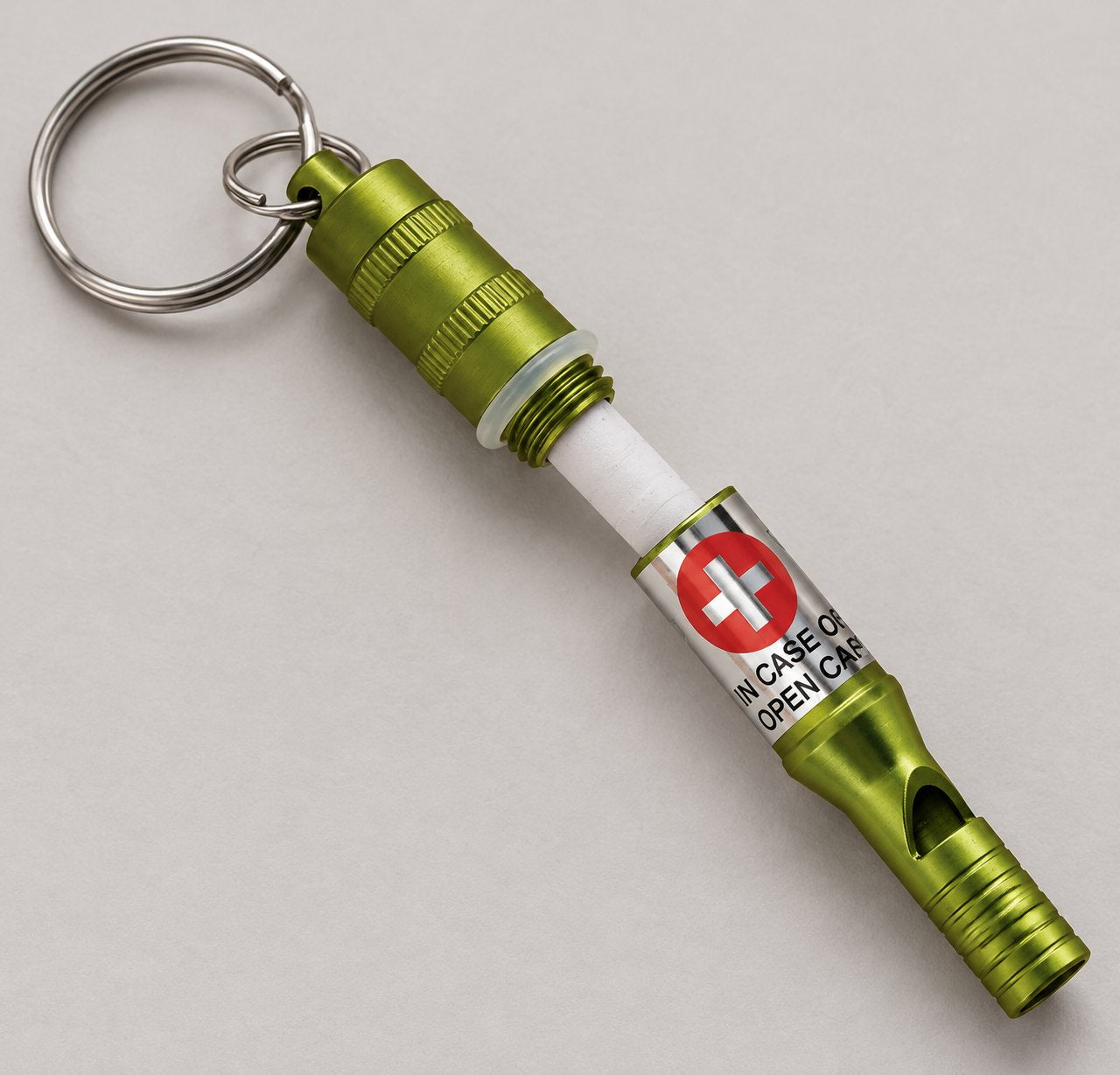 Open Munkees Emergency Whistle showing the cap, rolled paper insert and attached key rings