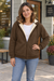 Woman wearing a coffee fleece-lined zip hoodie outside a neighborhood coffee shop.