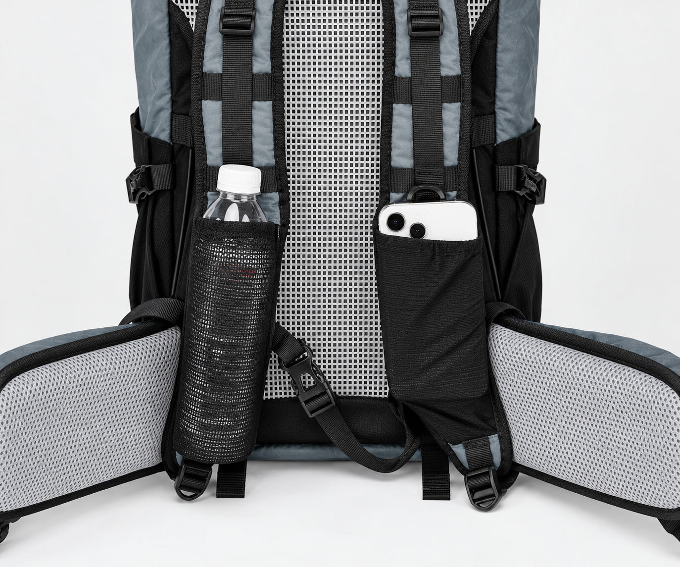 Large shoulder-strap pockets and gray mesh hip belt on the Royal Mountain 1316 backpack; accessories shown for scale