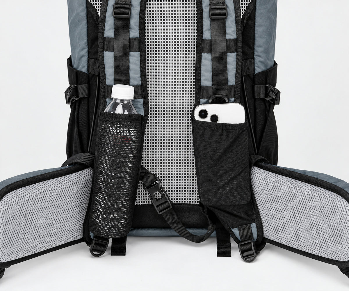 Large shoulder-strap pockets and gray mesh hip belt on the Royal Mountain 1316 backpack; accessories shown for scale