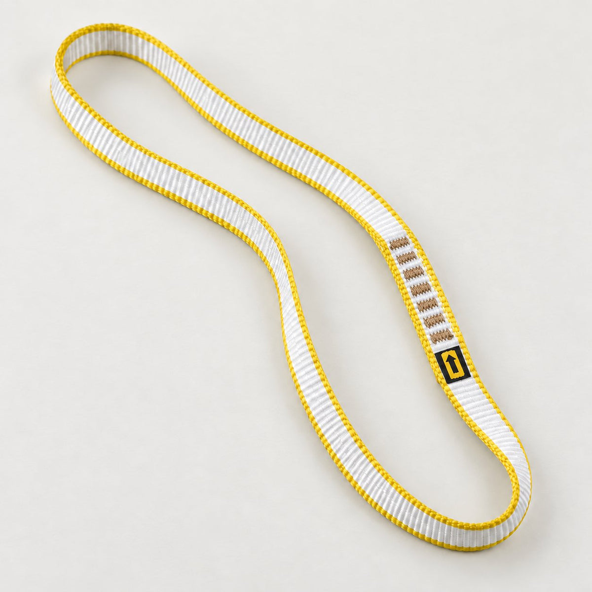 One Singing Rock 11 mm sewn loop sling with white webbing and yellow edges.