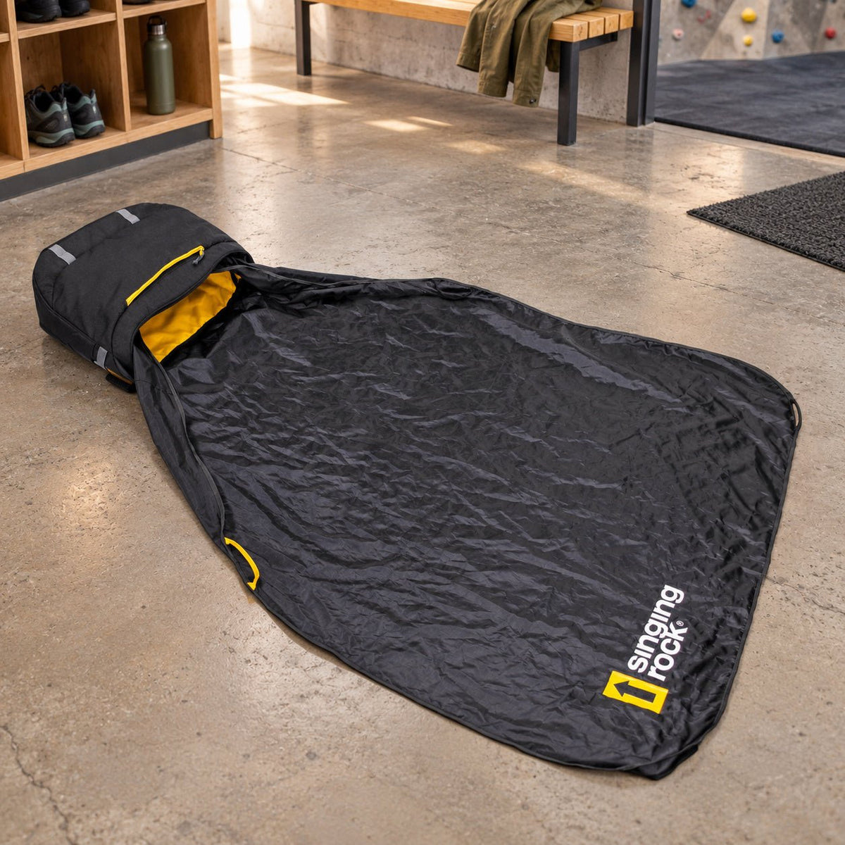 Rockstar bag and empty included rope tarp beside a climbing-gym bench