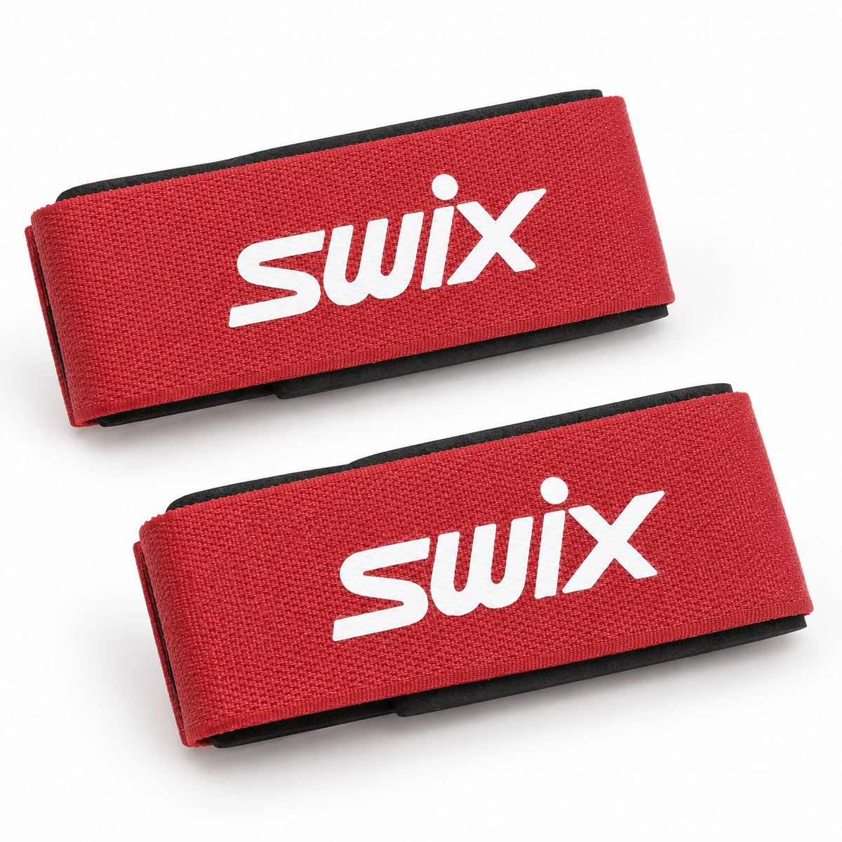 Two red Swix ski straps with white branding and black base protectors