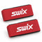 Two red Swix ski straps with white branding and black base protectors
