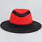 Red and black Tilley LTM6 Airflo hat on a neutral studio surface, showing the crown mesh band and complete brim.