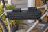 Black Topeak MidLoader 4.5L bag mounted inside a bicycle frame beside a home porch