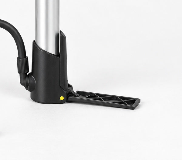 Detail of the silver Topeak Mountain Morph base, yellow pivot and narrow foot pad folded out on a studio surface.