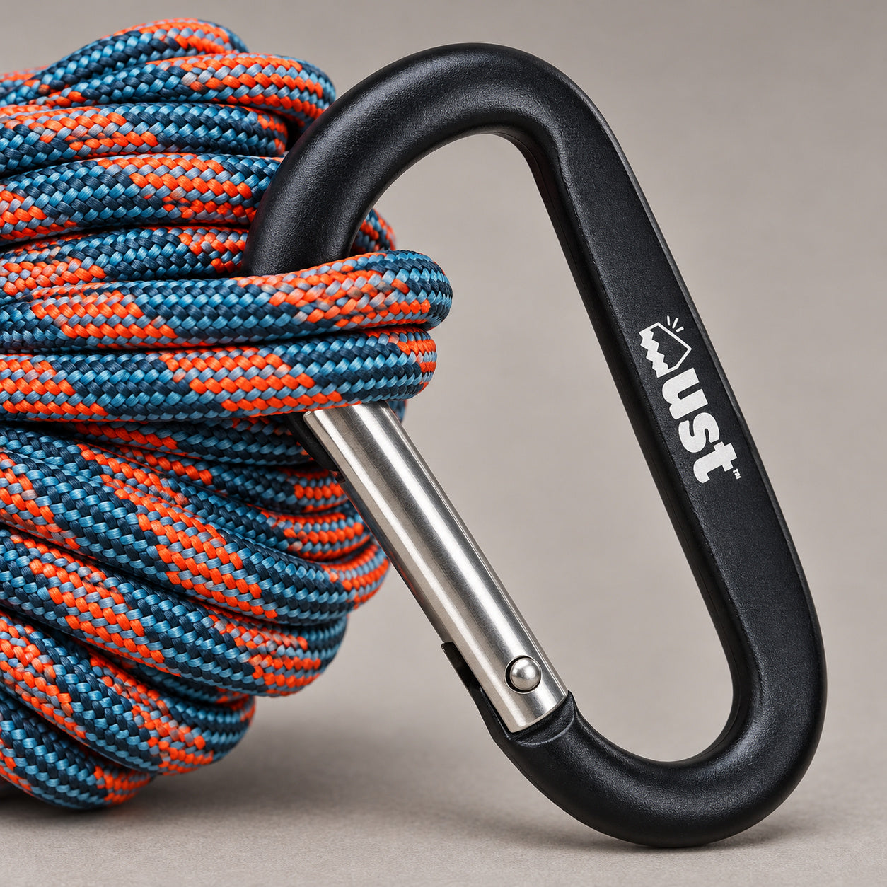 Close detail of the UST ParaTinder Orange/Blue utility cord carabiner and silver straight gate.
