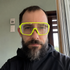 Indoor low-light selfie wearing High-Vis Yellow ApexShift clear-to-dark cycling glasses